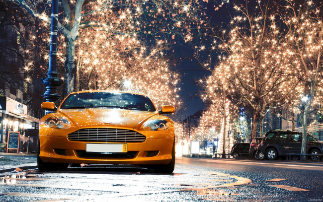Обои картинки фото aston, martin, db9, автомобили, улица, оранжевый, лампочки