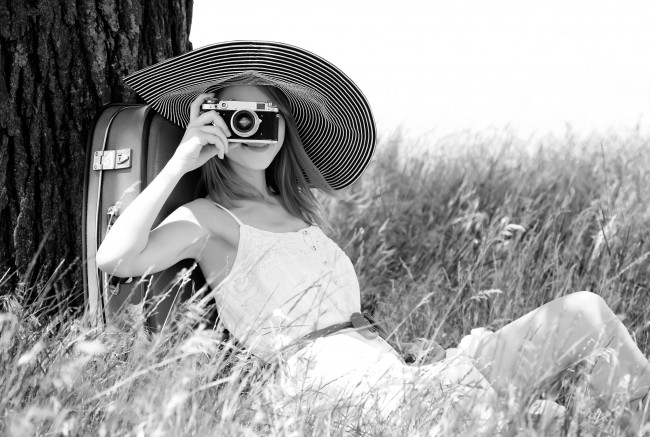 Обои картинки фото девушки, -unsort , черно-белые обои, платье, камера, фотоаппарат, шляпа, трава, дерево, чемодан